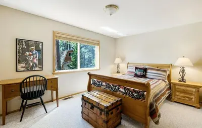 a bedroom with a bed and a desk and a chair at New Listing! Woodland Heights at Tahoe Park- Pet Friendly - Private Beach in Tahoe City