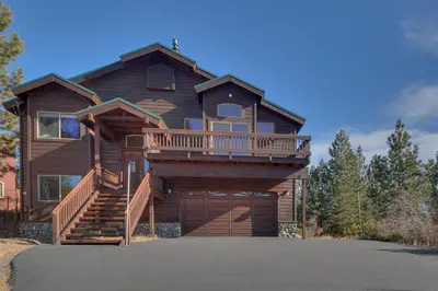 a large wooden house with a large garage at Stockholm - Beautiful Views in Tahoe Donner - Private Hot Tub - Pet Friendly in Truckee