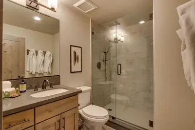 a bathroom with a shower and a toilet and a sink at Sunrise Abode at Tahoe Donner - Luxurious New Build, Soaking Tub, HOA Amenities in Truckee