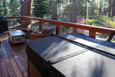 a trampoline on a deck with a table and chairs at Tahoe Wanderer - 3 BR Luxury Log Cabin with Additional Loft, Private Hot Tub in Tahoe Vista
