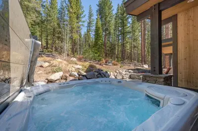 a jacuzzi tub in a house in the woods at Lavish 4 BR in Gray's Crossing in Truckee