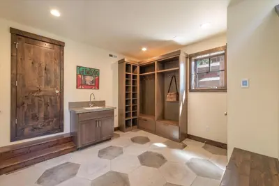 a bathroom with a sink and a wooden closet at Lavish 4 BR in Gray's Crossing in Truckee