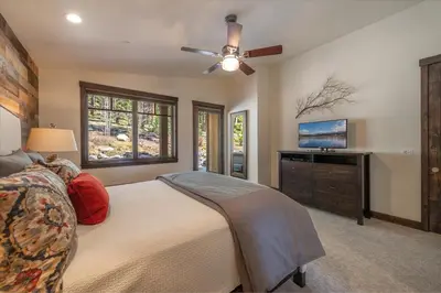 a bedroom with a bed and a flat screen tv at Lavish 4 BR in Gray's Crossing in Truckee