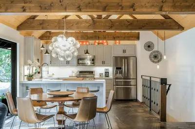 a kitchen with a wooden table and a dining room at Timber Grove at Tahoe Park - Gorgeous 4BR Cabin - Tahoe Park HOA, Pets OK, Near Skiing in Tahoe City