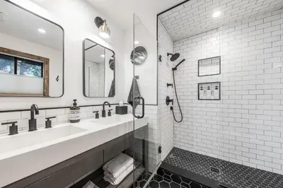 a white bathroom with two sinks and a shower at Timber Grove at Tahoe Park - Gorgeous 4BR Cabin - Tahoe Park HOA, Pets OK, Near Skiing in Tahoe City