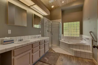 a bathroom with two sinks and a tub and a shower at Treetop at Tahoe Donner - Pet Friendly 4BR w Gym and Pool Access in Truckee
