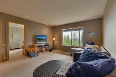 a living room with a couch and a television at Treetop at Tahoe Donner - Pet Friendly 4BR w Gym and Pool Access in Truckee
