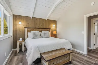 a bedroom with a bed and a wooden floor at Granlibakken Getaway by Tahoe Getaways - West Shore Retreat-Central Location-Hot Tub-Dog Considered-Near Skiing in Tahoe City
