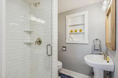a white bathroom with a toilet and a sink at Granlibakken Getaway by Tahoe Getaways - West Shore Retreat-Central Location-Hot Tub-Dog Considered-Near Skiing in Tahoe City
