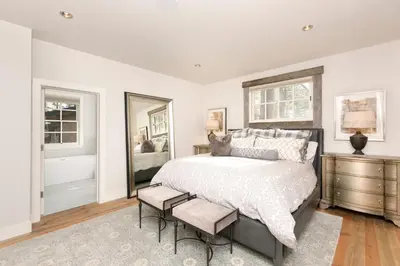 a bedroom with a large bed and a window at First Light Farmhouse- Hot Tub- Gourmet Kitchen- Premier Neighborhood in Truckee