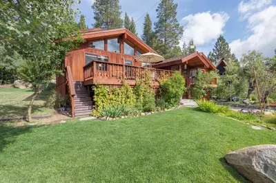 a log home with a lawn in front of it at Victory Place at Palisades - Stunning 5 BR with Private Hot Tub and Pool Table in Olympic Valley