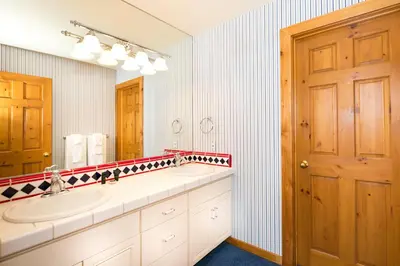 a bathroom with a sink and a mirror at Victory Place at Palisades - Stunning 5 BR with Private Hot Tub and Pool Table in Olympic Valley