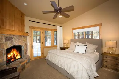 a bedroom with a bed and a fireplace at Truckee Treasure at Grays Crossing by Tahoe Getaways - Relaxing Home w Private Hot Tub, Dogs Welcome! in Truckee