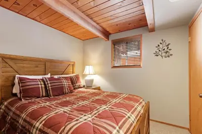 a bedroom with a bed and a wooden ceiling at Snowy Paws - Pet Friendly - Alpine Meadows - Amazing views, close to slopes in Olympic Valley