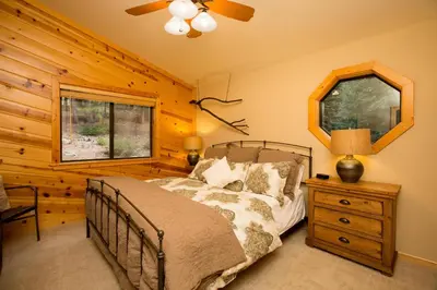 a bedroom with a bed and a mirror and a dresser at St Bernard at Tahoe Donner Remodeled 3BR - Private Hot Tub and Gym and Pool Access in Truckee