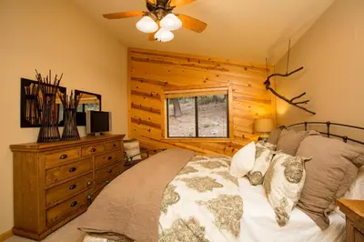 a bedroom with a bed and a ceiling fan at St Bernard at Tahoe Donner Remodeled 3BR - Private Hot Tub and Gym and Pool Access in Truckee