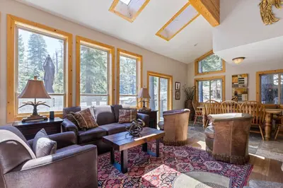 a living room with a couch and a table at Trailside - Alpine Meadows 6 Bedroom with Private Hot tub in Alpine Meadows