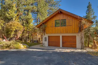 a house with a garage and a driveway at Swiss Chalet-Palisades, 6 BR, Hot Tub, Pets Ok, Ski Shuttle! in Olympic Valley