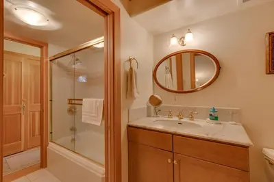 a bathroom with a sink and a shower and a mirror at Creek Side- 4 Primary Suites, Hot Tub, Shuttle to Slopes, Pet Friendly in Olympic Valley