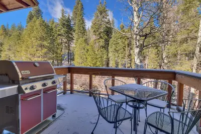 a patio with a grill and a table and chairs at Creek Side- 4 Primary Suites, Hot Tub, Shuttle to Slopes, Pet Friendly in Olympic Valley