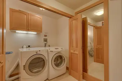 a laundry room with a washing machine and a sink at Creek Side- 4 Primary Suites, Hot Tub, Shuttle to Slopes, Pet Friendly in Olympic Valley