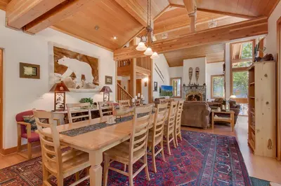 a dining room and living room with a table and chairs at Creek Side- 4 Primary Suites, Hot Tub, Shuttle to Slopes, Pet Friendly in Olympic Valley