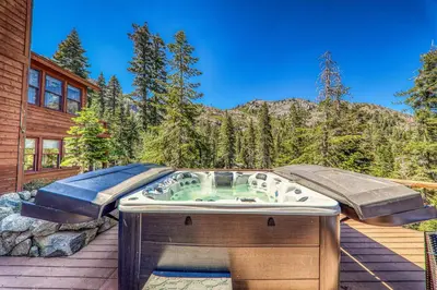 a hot tub on the deck of a house at Eagles Nest by Tahoe Getaways - Pet Friendly with Hot Tub, Pool Table & Shuttle to Slopes in Olympic Valley