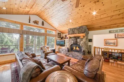a living room with a couch and a fireplace at Fawn View by Tahoe Getaways - Spacious 5 BR w Pool Table-Short Drive to Northstar in Tahoe Vista