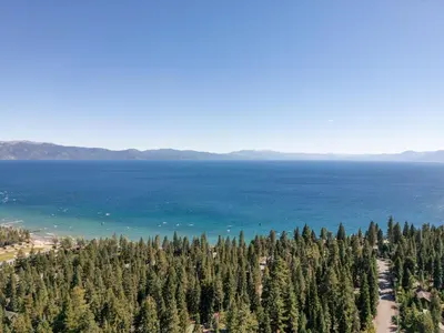 an aerial view of a forest of trees next to the ocean at Fawn View by Tahoe Getaways - Spacious 5 BR w Pool Table-Short Drive to Northstar in Tahoe Vista