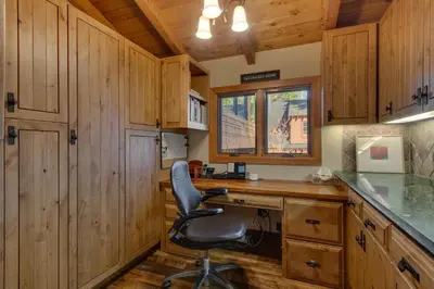 a office with a desk and a chair in a kitchen at Gray Bear Lake View Estate - Stunning Cabin w 4 Master Suites, Private Hot Tub! in Carnelian Bay