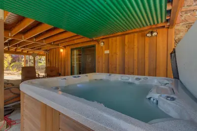 a large jacuzzi tub in a house at Gray Bear Lake View Estate - Stunning Cabin w 4 Master Suites, Private Hot Tub! in Carnelian Bay
