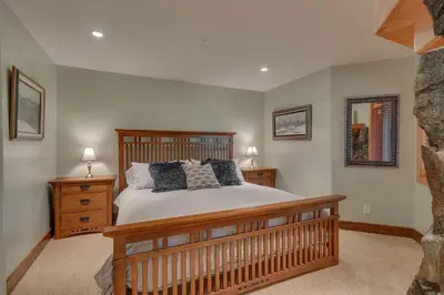 a bedroom with a large bed and two night stands at Gray Bear Lake View Estate - Stunning Cabin w 4 Master Suites, Private Hot Tub! in Carnelian Bay