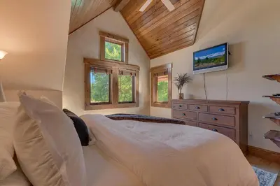 a bedroom with a bed and a dresser and windows at Highland Estate at Old Greenwood - Large, Luxury, Private Hot Tub & Amenity Access in Truckee