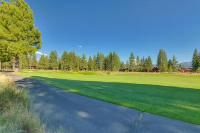 a golf course with a green field and trees at Highland Estate at Old Greenwood - Large, Luxury, Private Hot Tub & Amenity Access in Truckee