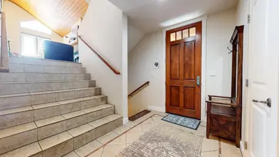 a hallway with stairs and a wooden door at Mammoth Gateway Village #6 condo in Mammoth Lakes