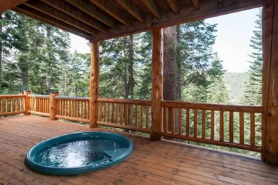 a large blue tub sitting on a porch of a cabin at Sierra Crest at Palisades Tahoe - Secluded Luxury 5BR 5 BA w Wood Fireplace in Olympic Valley