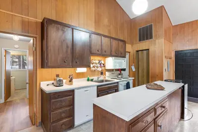 a kitchen with wooden cabinets and a white appliance at Starry Skies on the West Shore, Private Beach, Fireplace, Pet Friendly, Close to Ski Resorts in Tahoe City