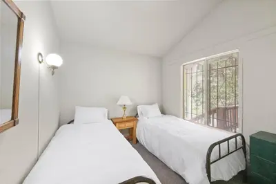 two beds in a room with a window at Starry Skies on the West Shore, Private Beach, Fireplace, Pet Friendly, Close to Ski Resorts in Tahoe City