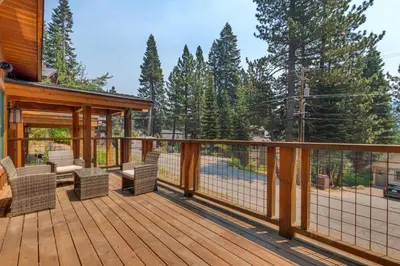 a wooden deck with chairs and a gazebo at Summit Solitude at Palisade Tahoe - Charming 5BR w Foosball & Shuffleboard Table & Pet Friendly in Olympic Valley
