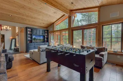 a large living room with a foosball table at Summit Solitude at Palisade Tahoe - Charming 5BR w Foosball & Shuffleboard Table & Pet Friendly in Olympic Valley