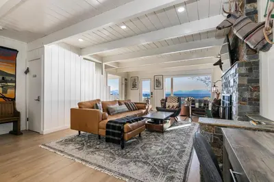 a living room with a couch and a fireplace at Beach Haven Lakefront - On a Sandy Beach with Guest House in Kings Beach