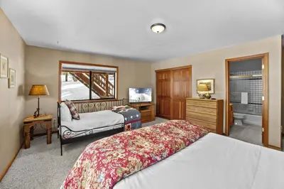 a bedroom with a bed and a desk and a mirror at 4 Bedroom Home at 392 Skidder Trail home in Truckee