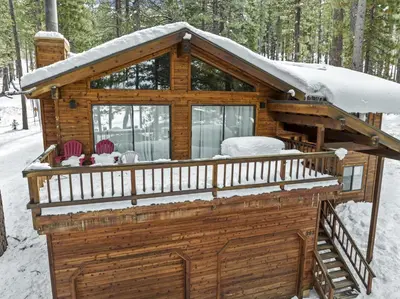 a log cabin with a snow covered roof at 4 Bedroom Home at 392 Skidder Trail home in Truckee