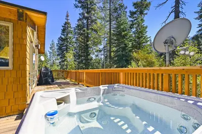 a hot tub on the deck of a house at Alpine Adventure- Shuttle to Ski Lifts- Hot Tub- Pet Friendly in Alpine Meadows