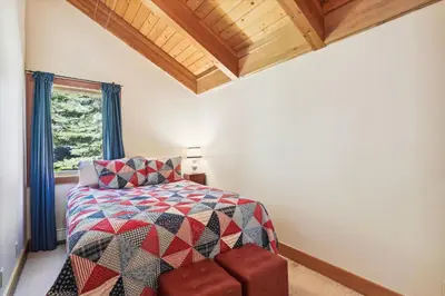 a bedroom with a bed and a window at Alpine Adventure- Shuttle to Ski Lifts- Hot Tub- Pet Friendly in Alpine Meadows