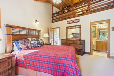 a bedroom with a bed and a dresser and a mirror at Alpine Adventure- Shuttle to Ski Lifts- Hot Tub- Pet Friendly in Alpine Meadows