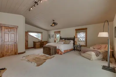 a large bedroom with a bed and a couch at Above the Pines - Hot Tub- Pet Friendly -Gym and Pool Access in Truckee