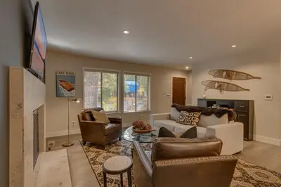 a living room with a couch and a tv at Antler House- Quiet, Charming Cabin w Cozy Fireplace, Close to Skiing in Tahoe City