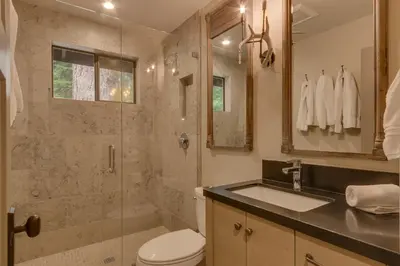 a bathroom with a shower and a toilet and a sink at Antler House- Quiet, Charming Cabin w Cozy Fireplace, Close to Skiing in Tahoe City