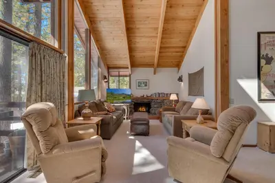a living room with couches and a fireplace at Base Camp at Dollar Point by Tahoe Getaways - Hot Tub, Large Deck, Wood Fireplace, Short Drive to Ski Resorts! in Tahoe City